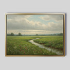 The Winding Stream Canvas Art features a framed green landscape with a serene stream flowing through a wildflower meadow under partly cloudy skies—an ideal large wall art piece for minimalist spaces.