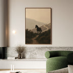A modern living room featuring a green sofa, marble accents, and atmospheric décor—a Winding Trail Canvas Art depicting a black horse on a misty hillside. A vase with dried branches rests on the low shelf.