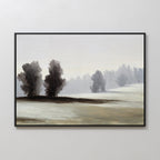 The Winter Dusk Canvas Art features a framed misty landscape with tall, bare trees on snowy hills under a pale sky—ideal as neutral wall decor for any room.