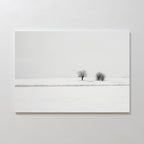 Winter Silence Canvas Art features a minimalist snow-covered landscape with two bare trees under a pale sky and three birds flying above—ideal for serene winter decor or elegant minimalist wall art.