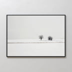 Winter Silence Canvas Art captures a minimalist snow-covered landscape with two leafless trees and three birds beneath a pale sky. This serene scene, framed simply, makes perfect minimalist wall art for any space.
