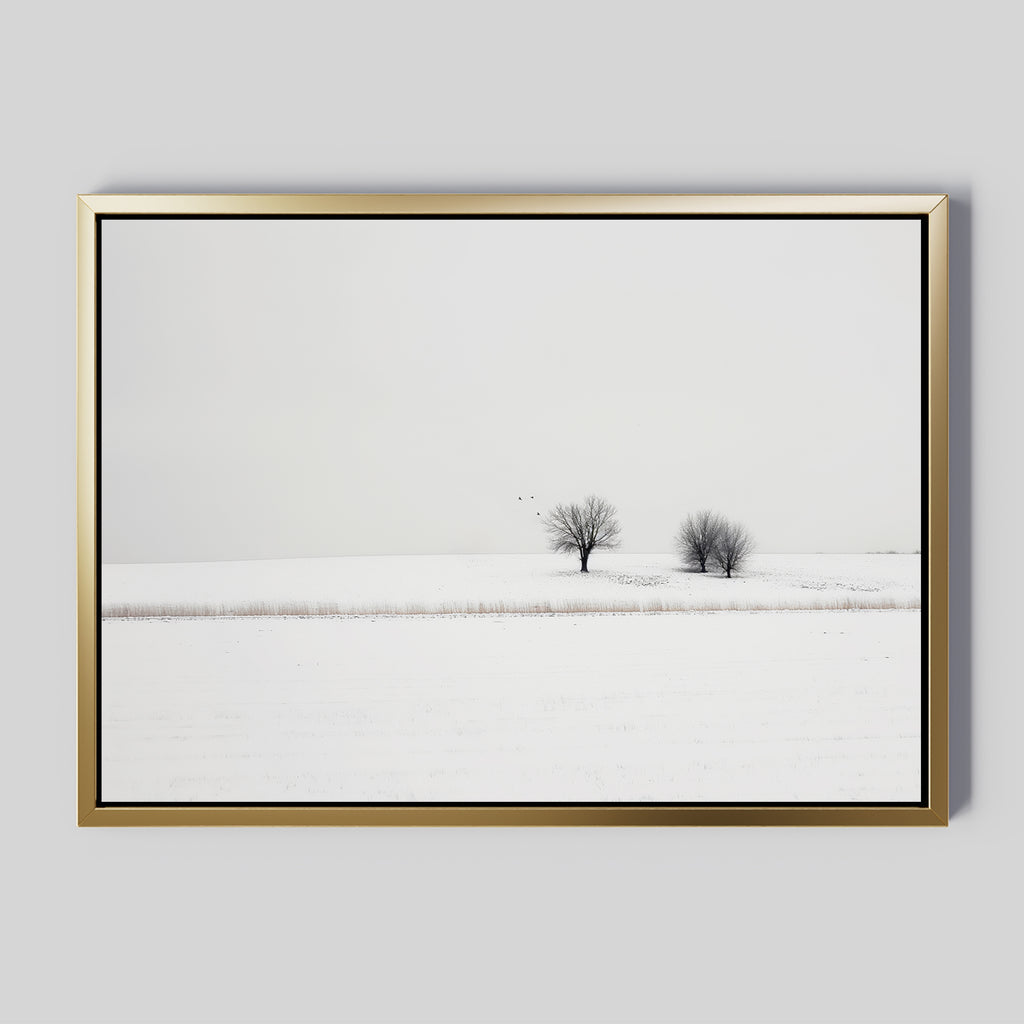Winter Silence Canvas Art features a snow-covered landscape with two bare trees under an overcast sky and three birds in flight, creating minimalist wall decor that adds serene winter charm to any room.