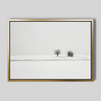 Winter Silence Canvas Art features a snow-covered landscape with two bare trees under an overcast sky and three birds in flight, creating minimalist wall decor that adds serene winter charm to any room.