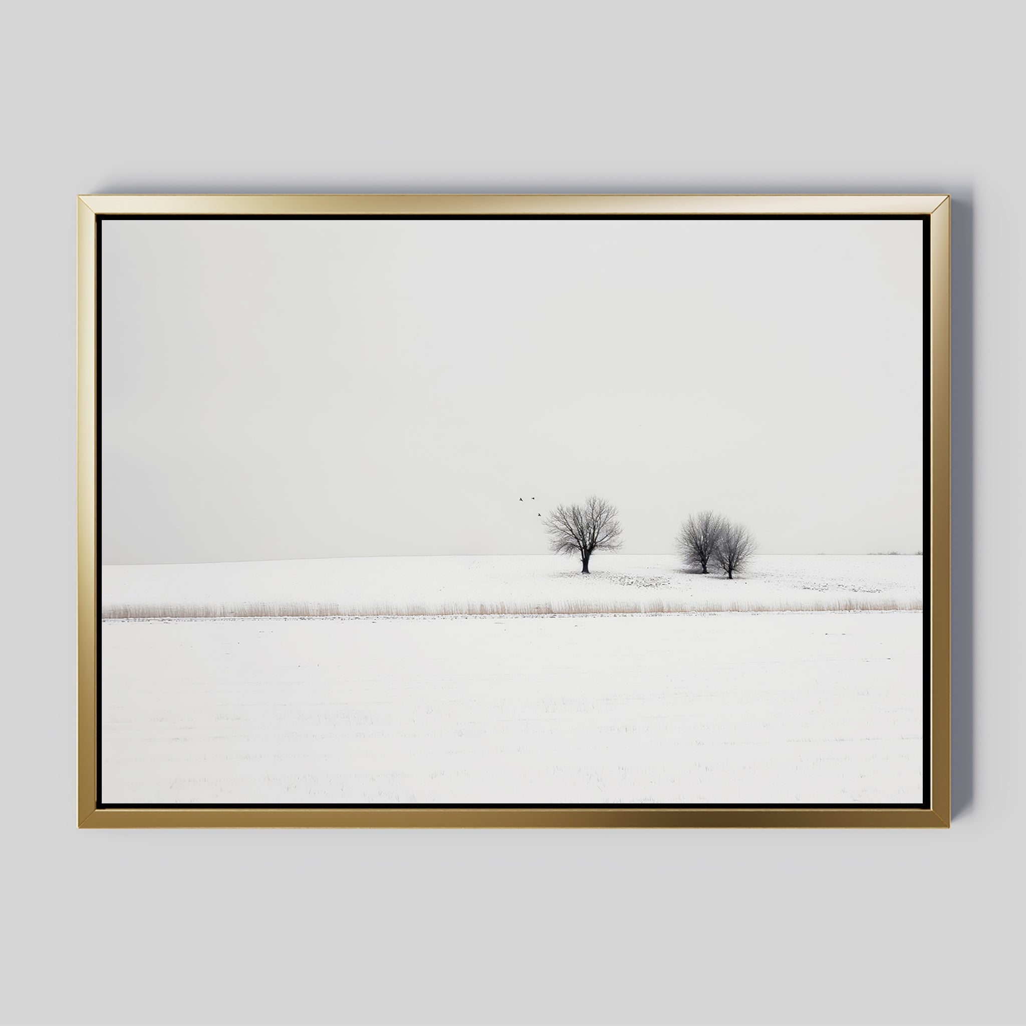 Winter Silence Canvas Art features a snow-covered landscape with two bare trees under an overcast sky and three birds in flight, creating minimalist wall decor that adds serene winter charm to any room.