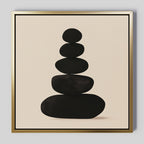 The Zen Balance Canvas Art features five black oval stones stacked on a beige background with a gold border, bringing balance and calm to your living room decor.