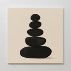 Zen Balance Canvas Art showcases five smooth black oval stones stacked on a light beige background, creating a minimalist and calming wall art piece—ideal for bringing serenity to your living room decor.