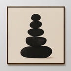 Zen Balance Canvas Art features five smooth black stones stacked on a beige background, framed in thin dark wood. This minimalist print brings balance and simplicity, perfect as calming wall decor for your living room.