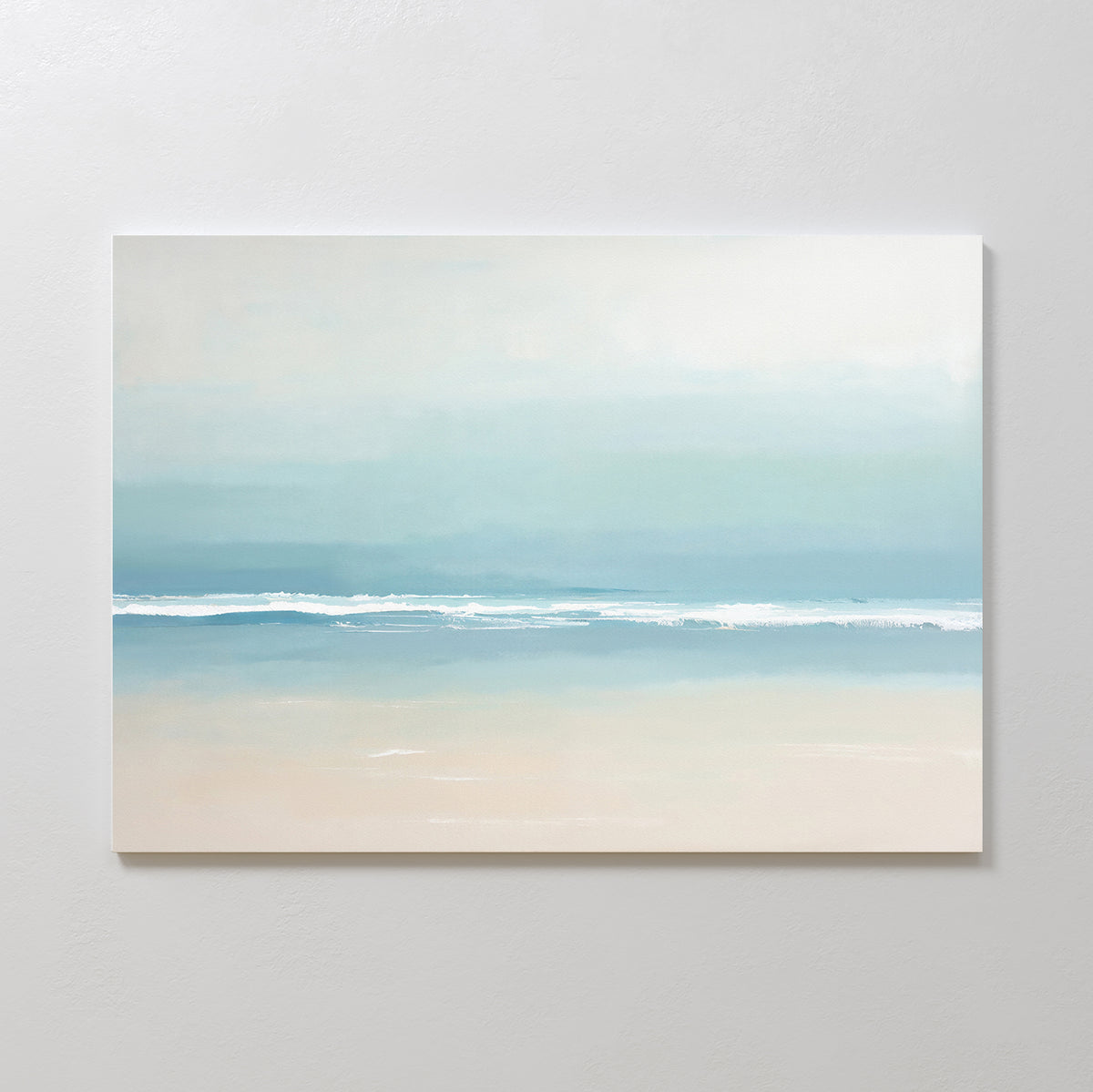 The Airy Shore Canvas Art - Horizontal showcases a minimalist beach scene in soft blues, white, and beige, with gentle waves meeting the sand—perfect for Nordic Park wall art to create a tranquil seaside vibe.