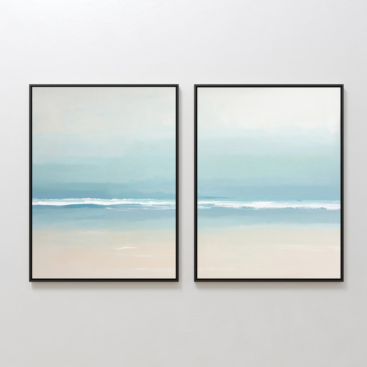 The Airy Shore - Set Of 2 features framed coastal wall art in soft blue and beige, showcasing a serene beach and gentle ocean waves under a pale sky, perfect for display side by side on a white wall.