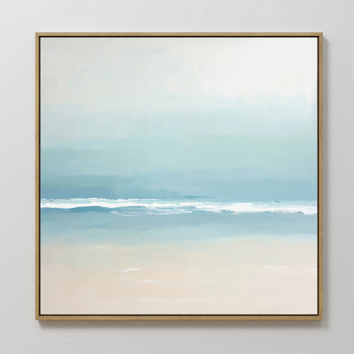 Airy Shore Canvas Art - Square features a minimalist coastal seascape in soft pastels. Gentle blue waves meet a sandy shore beneath a misty sky, creating tranquil Nordic wall art ideal for adding serenity to your seaside decor.