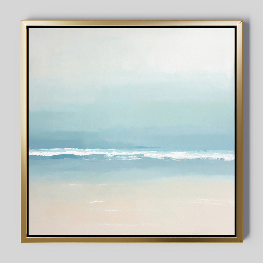 The Airy Shore Canvas Art - Square is a minimalist coastal print depicting a serene seascape with gentle waves and soft blue, white, and beige hues, elegantly framed in a slim metallic gold frame.