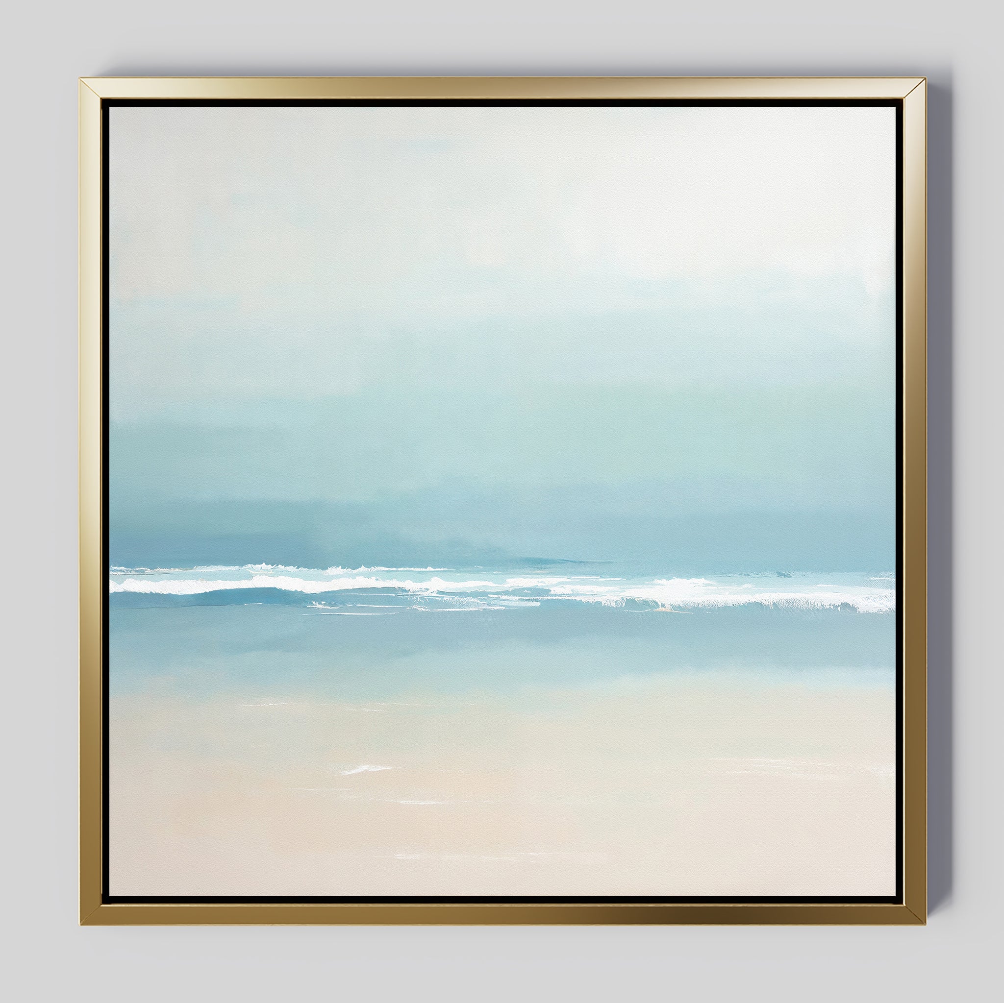 The Airy Shore Canvas Art - Square is a minimalist coastal print depicting a serene seascape with gentle waves and soft blue, white, and beige hues, elegantly framed in a slim metallic gold frame.