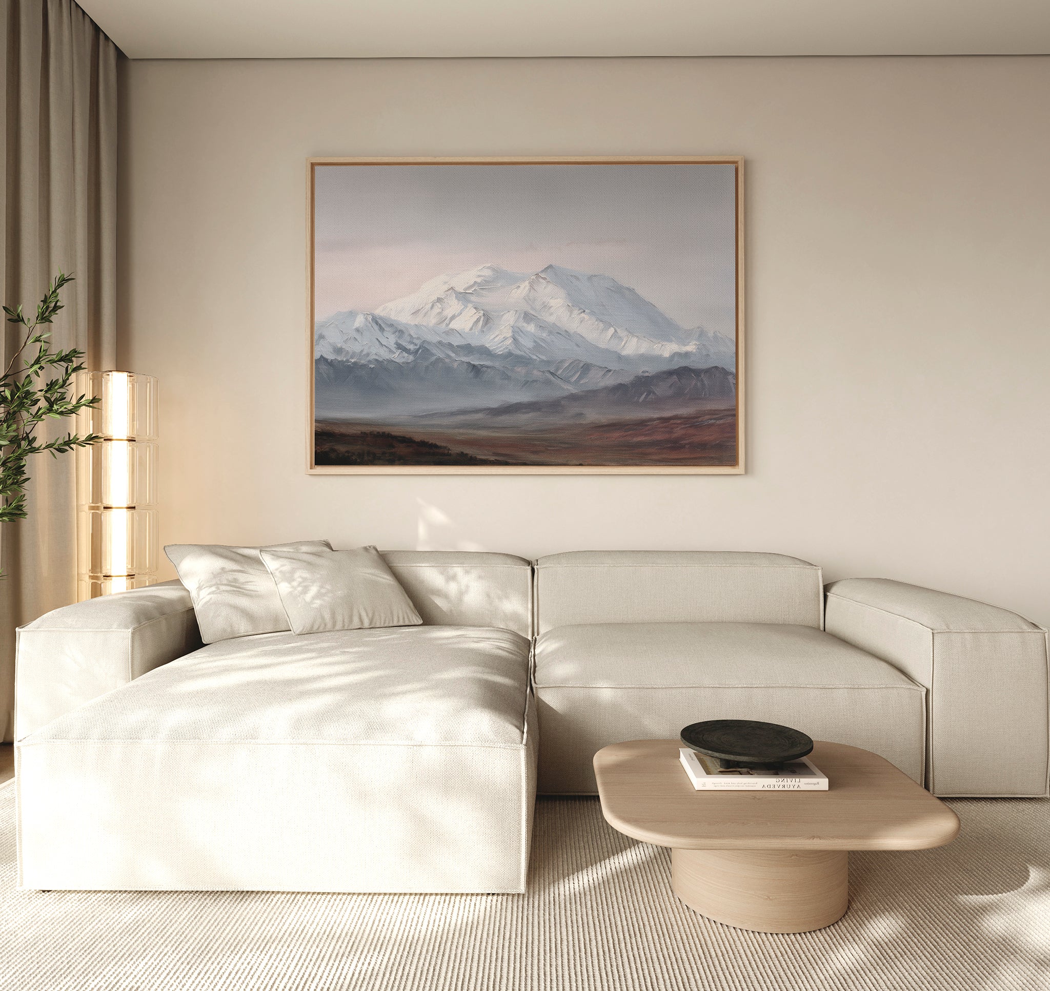 A modern living room features a light beige sectional sofa, a wooden coffee table, and the Alpine Majesty Canvas Art - Horizontal above the sofa. Soft natural light streams in through a window with sheer curtains.