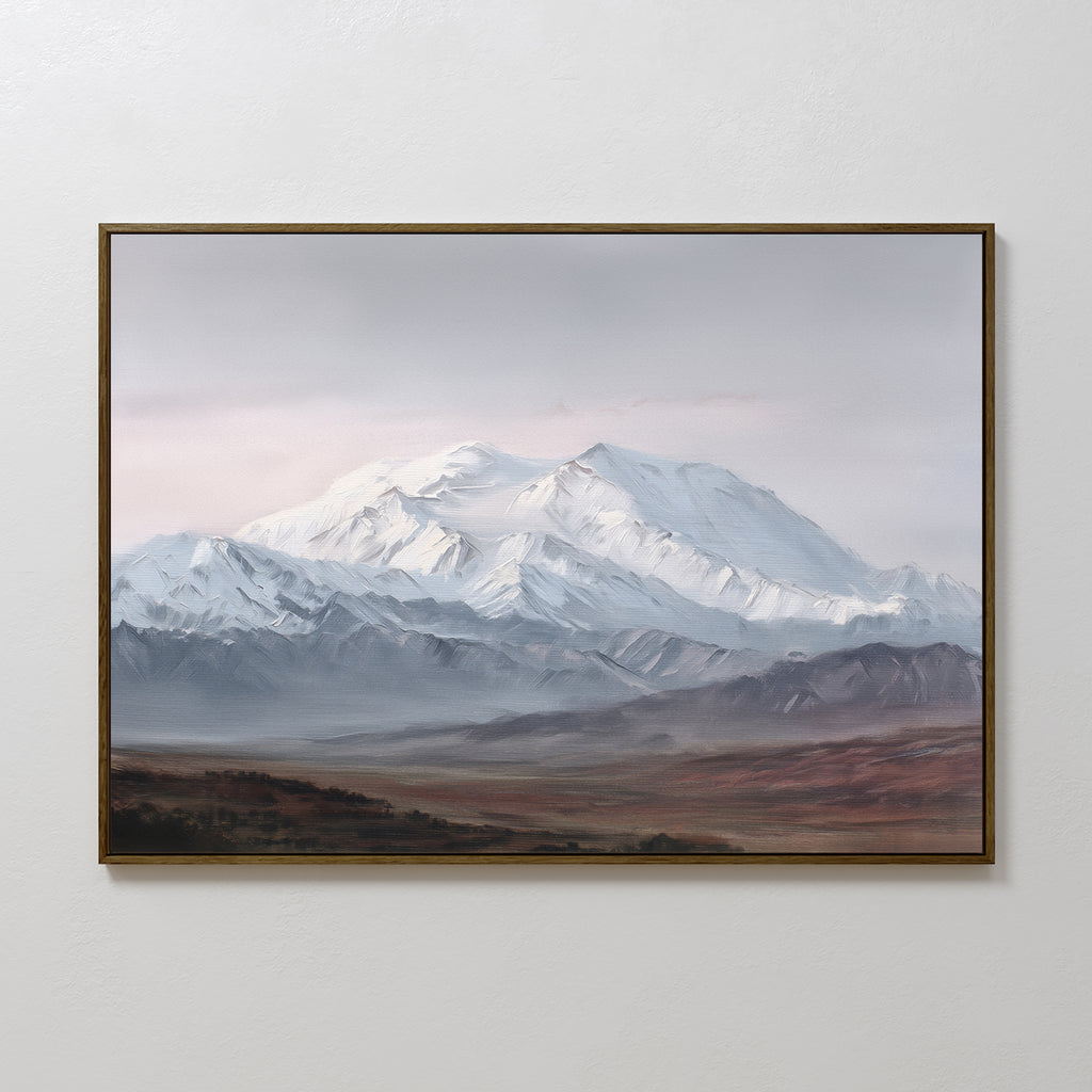 The Alpine Majesty Canvas Art - Horizontal features snow-covered mountain peaks beneath a cloudy sky, with muted green-brown hills in front, creating a serene focal point on any plain white wall.
