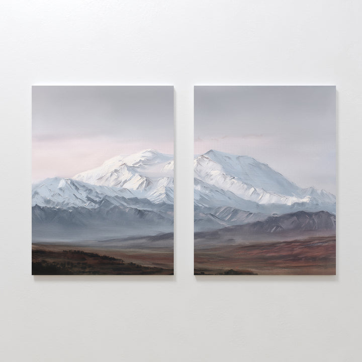 Alpine Majesty - Set of 2 showcases side-by-side mountain canvas prints with snow-capped peaks, a cloudy sky, and earthy plains. This Nordic Park-inspired wall art features serene, muted tones for a calming decor accent.