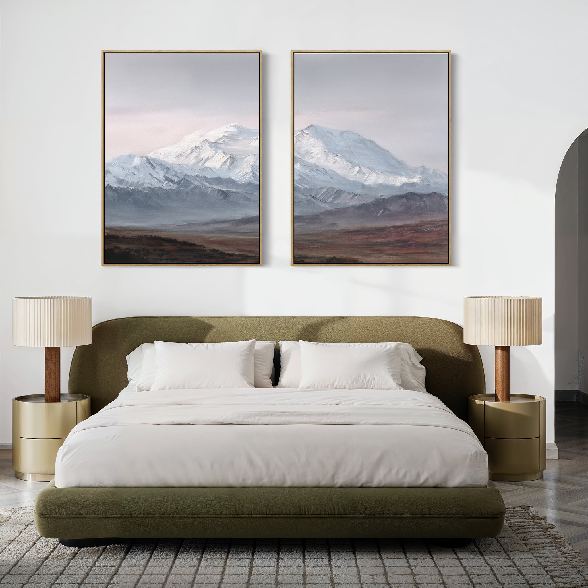 A modern bedroom featuring a green upholstered bed, white bedding, beige nightstands, and Alpine Majesty - Set of 2 mountain canvas prints above the bed. The neutral, minimalist decor creates a calming retreat.