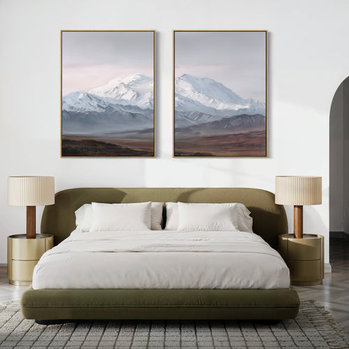 A modern bedroom featuring a green upholstered bed, white bedding, beige nightstands, and Alpine Majesty - Set of 2 mountain canvas prints above the bed. The neutral, minimalist decor creates a calming retreat.