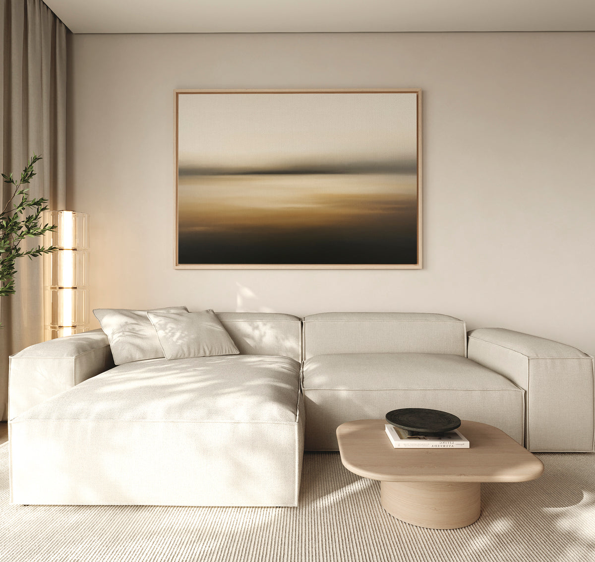 A modern living room features a light beige sectional, a low wooden coffee table with a black bowl, the Amber Fields Canvas Art - Horizontal on the wall, and a tall plant by beige curtains. Soft natural light fills the space.