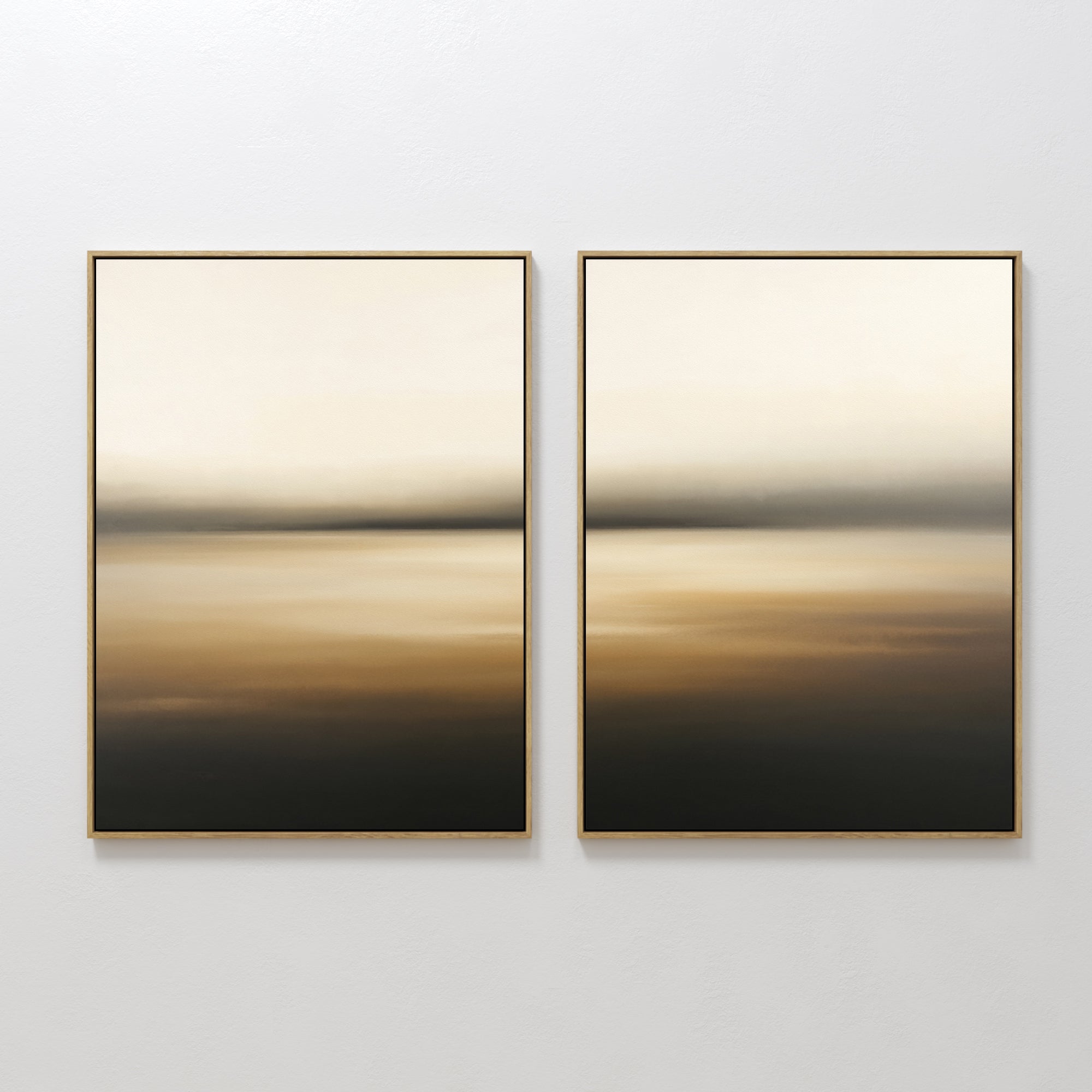Amber Fields - Set Of 2 shows two framed abstracts with soft, blurred beige, brown, and black gradients. Hung side by side on a white wall, they evoke a calm Nordic Park mood with minimalist landscape inspiration.