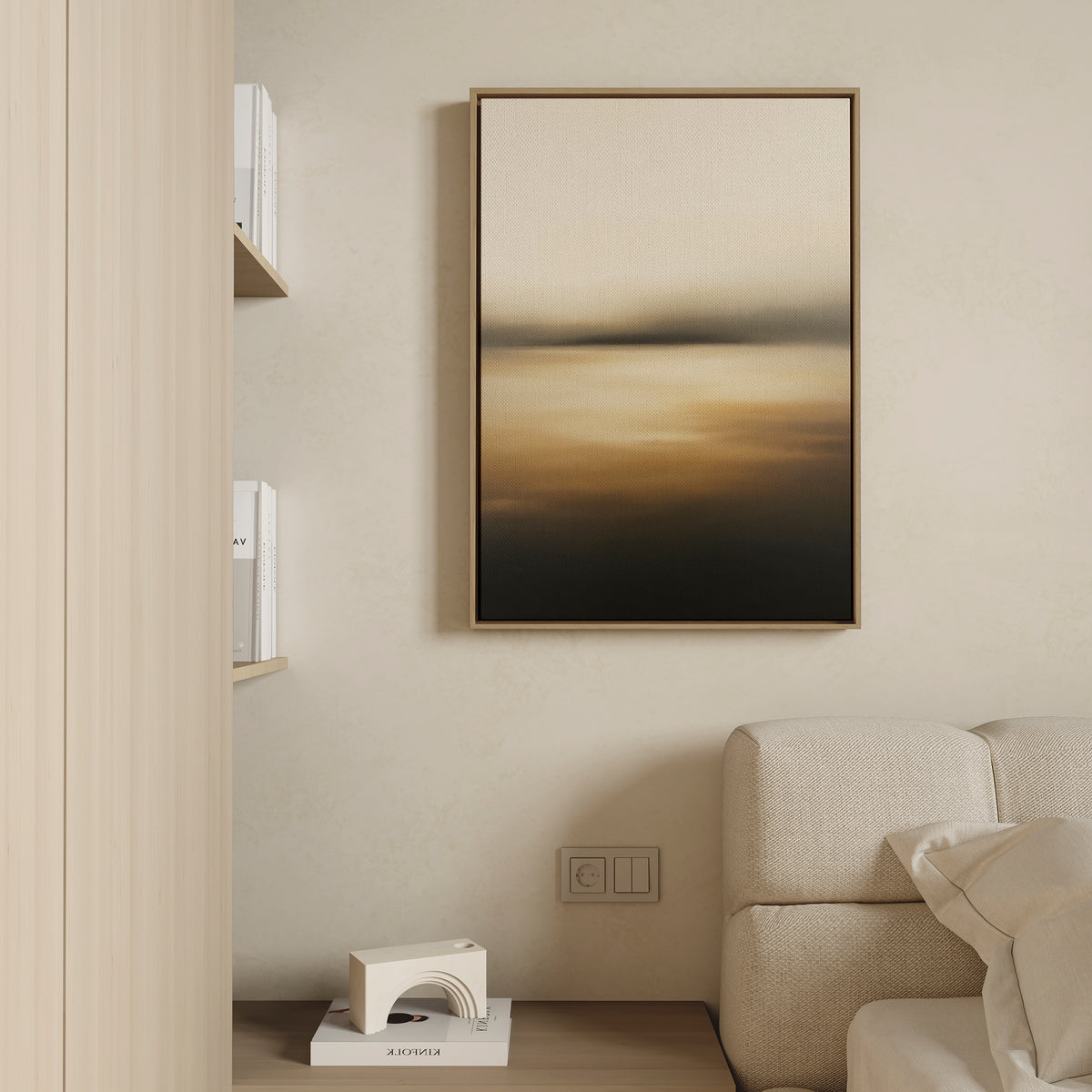 A minimalist living space features a beige sofa, a wooden shelf with books, and the Amber Fields Canvas Art - Vertical in amber tones hanging on a light wall. A small geometric sculpture rests on the shelf below.