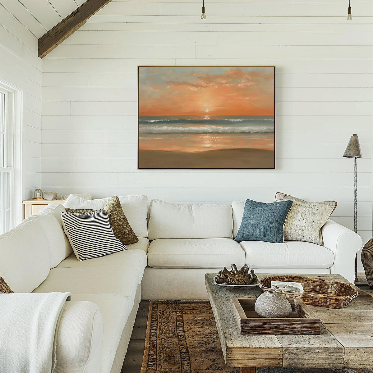 A cozy living room with white shiplap walls, a white sectional sofa with assorted pillows, a rustic wooden coffee table, and the Amber Horizon Canvas Art - Horizontal hanging above the couch.