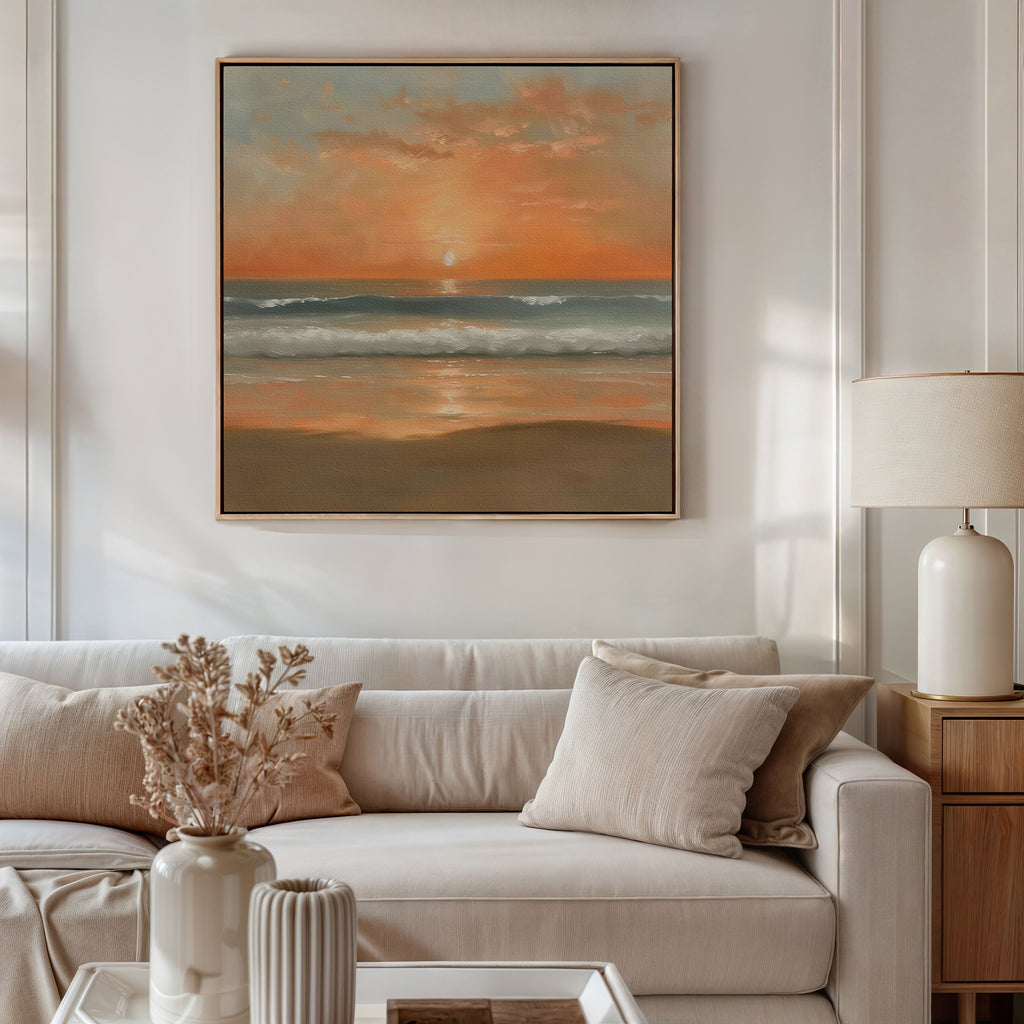 A cozy, neutral-toned living room features a white sofa, beige pillows, and a table lamp. Above the sofa hangs the Amber Horizon Canvas Art - Square, while dried flowers in a vase add charm to the coffee table.