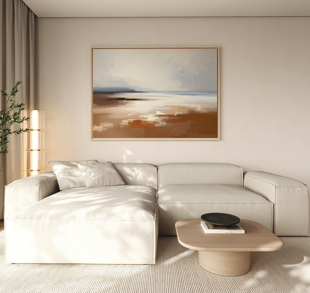 A modern living room with a light beige sectional sofa, wooden coffee table, black decorative bowl, tall plant, and tranquil Amber Shore Canvas Art - Horizontal on a white wall. Natural light fills the space.