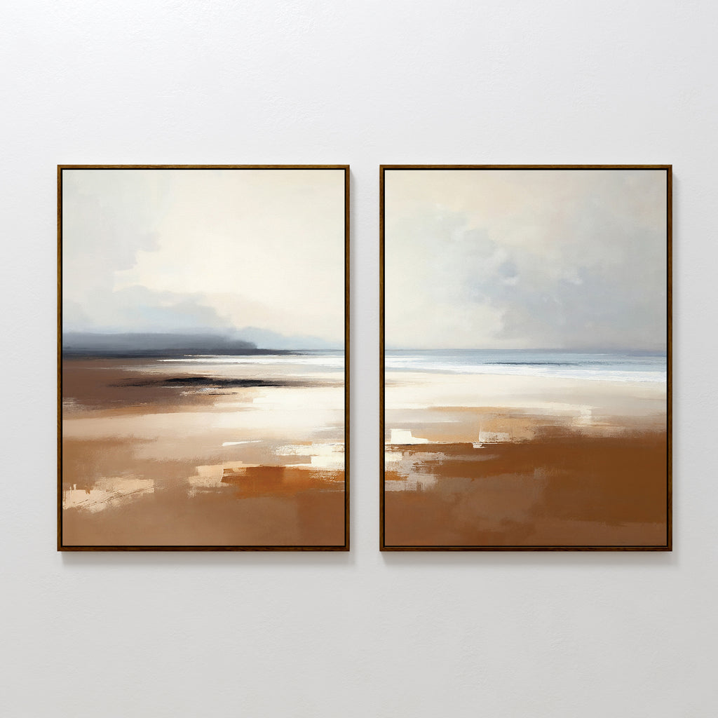 Amber Shore - Set Of 2 features two framed abstract prints in soft brown, beige, white, and blue tones, capturing a peaceful beach scene—ideal tranquil wall art that evokes sand, sky, and calm waters.
