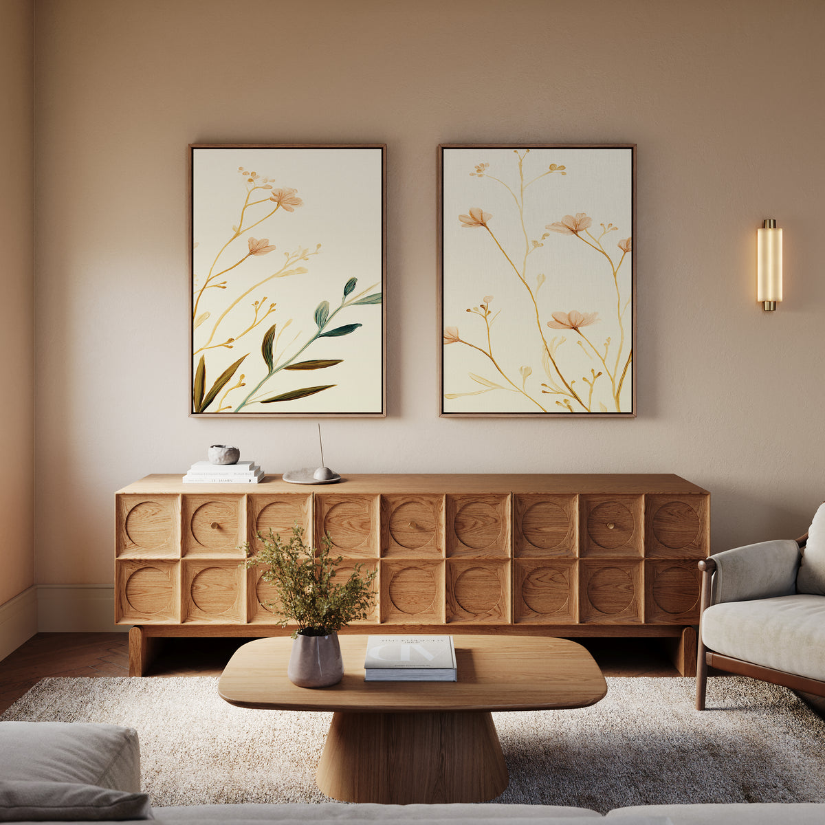 A cozy living room with a wooden sideboard, round coffee table with a book and vase, light armchair, wall sconce for warm lighting, and the Autumn Botanicals - Set of 2 canvas prints adding botanical elegance to the wall.