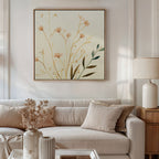 A neutral-toned living room features a beige sofa, cream pillows, a lamp on a wooden side table, and a vase of dried flowers. Above the sofa hangs the Autumn Botanicals Canvas Art - Square, bringing Nordic Park charm to the space.