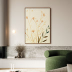 A modern living room with a green curved sofa, marble accents, a small vase of dried flowers, and the Autumn Botanicals Canvas Art - Vertical adding delicate yellow and green botanical elegance.