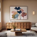 A modern living room with a wooden sideboard, coffee table, light sofa, floral vase, and the Autumn Garden Canvas Art - Horizontal as striking modern wall art above the sideboard.