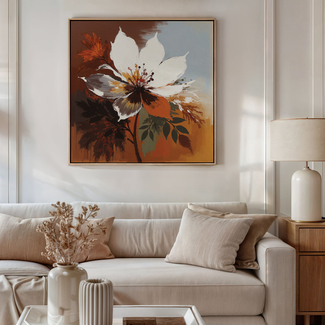 A cozy living room with a white sofa, beige cushions, a side table with a white lamp, dried flowers in a vase, and the Autumn Radiance Canvas Art - Square featuring bold florals hanging above the sofa.