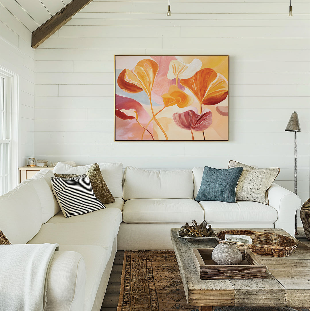 A bright living room with white shiplap walls, a large white sectional with assorted pillows, a rustic wood coffee table, and the Autumn Reverie Canvas Art - Horizontal displayed above the sofa for a refreshing touch.