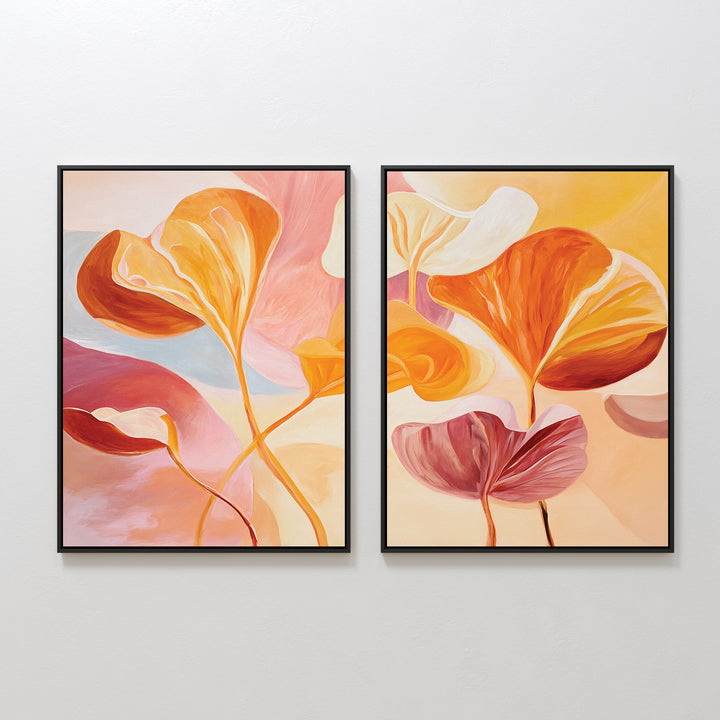 The "Autumn Reverie - Set of 2" features framed abstract paintings of large, colorful leaves in orange, yellow, pink, and white, creating stunning botanical wall art displayed side by side on a plain white wall.