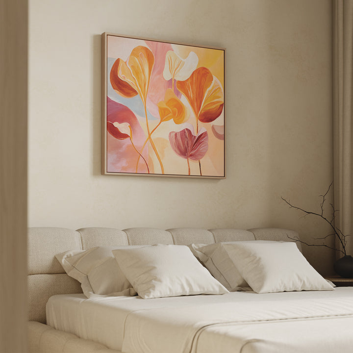A modern bedroom with a beige upholstered bed, white pillows, and the Autumn Reverie Canvas Art - Square featuring abstract floral designs above the headboard. Natural light and neutral tones create a calm atmosphere.
