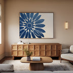 A modern living room features a wooden sideboard, coffee table, light gray sofa, beige rug, and the Azure Radiance Canvas Art - Horizontal with its striking blue flower above the sideboard—ideal for stylish, contemporary decor.