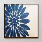 The Azure Radiance Canvas Art - Square features a bold, indigo flower on a light beige background. This framed floral wall art adds striking modern decor and vibrant style to any room.