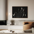 A modern living room with a beige sofa, marble-topped cabinet, and minimalist decor. Above a vase of dried flowers on the cabinet hangs the Botanical Silhouettes Abstract Canvas Art in black and white.