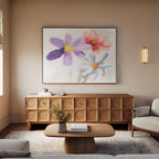A cozy living room with a modern wooden sideboard, light sofa, wooden coffee table, beige rug, and the Blooming Harmony Canvas Art - Horizontal featuring purple, red, and white flowers hanging above the sideboard.