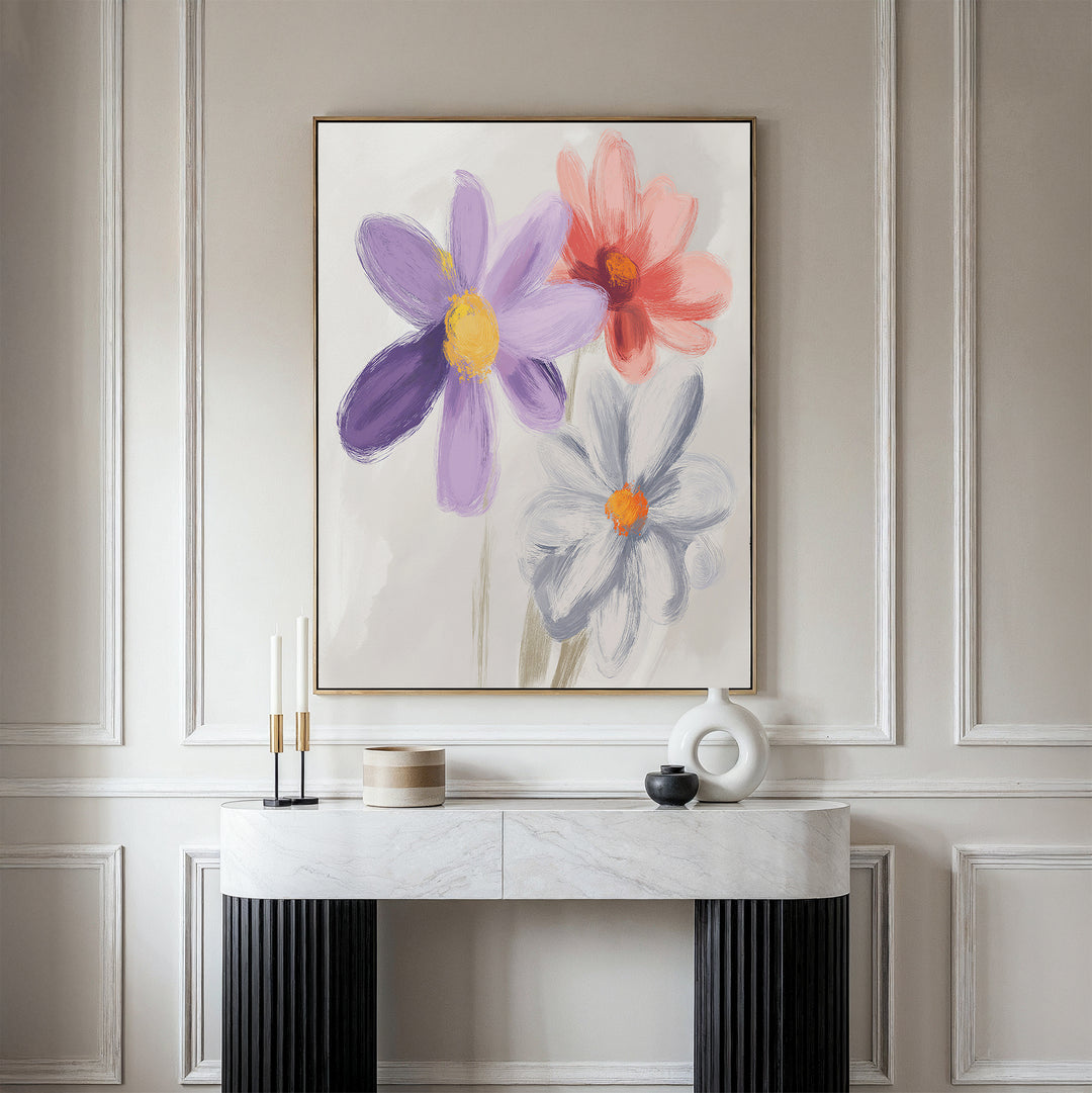 A modern interior features a marble console table, decor accents, and the Blooming Harmony Canvas Art - Vertical—a large floral print with purple, red, and white blooms—adding botanical charm to the light beige wall.