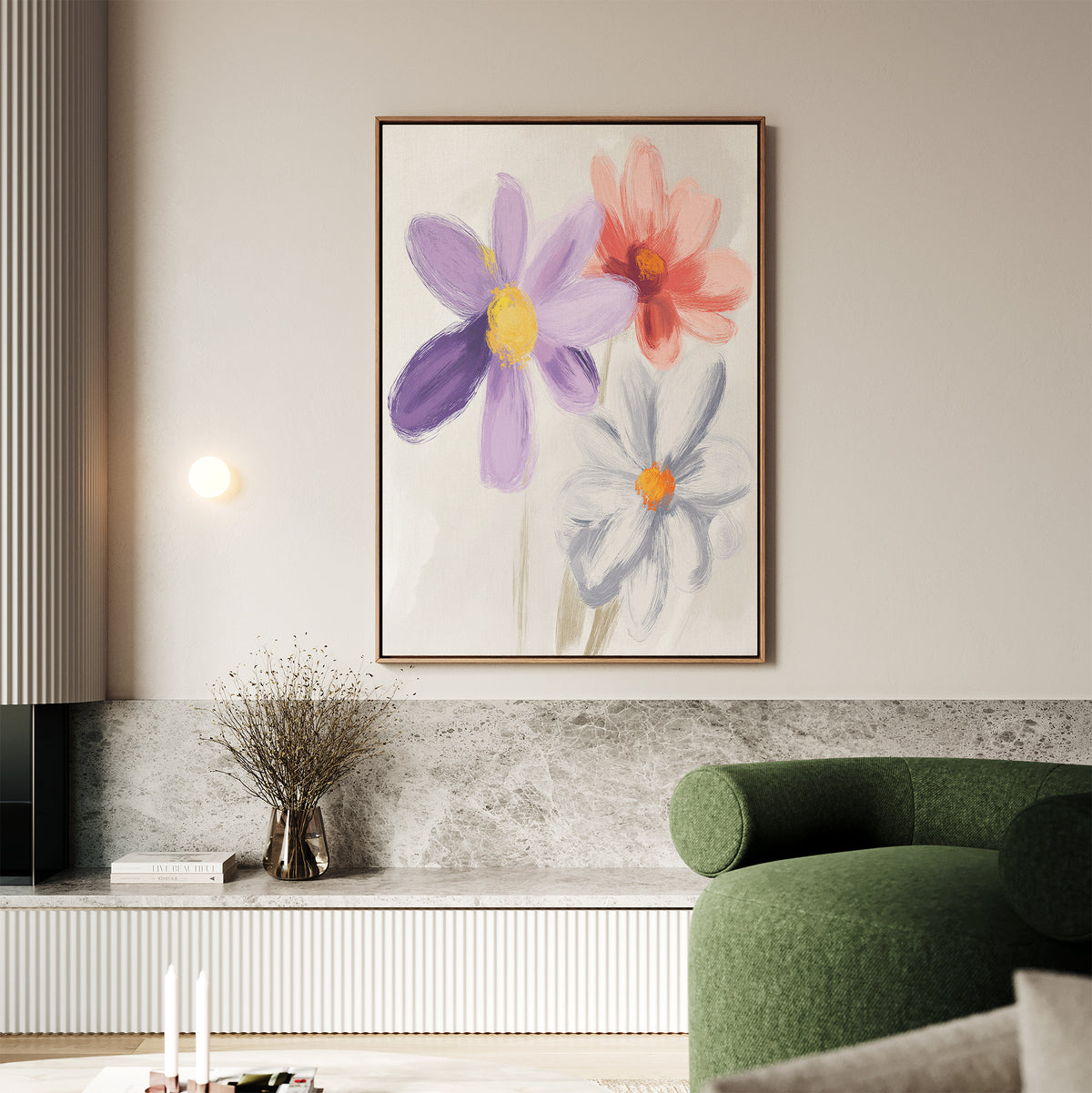 A modern living room with a green curved sofa, marble ledge, and the Blooming Harmony Canvas Art - Vertical featuring three colorful abstract flowers. A small light and vase with dried branches complete this Nordic Park-inspired space.