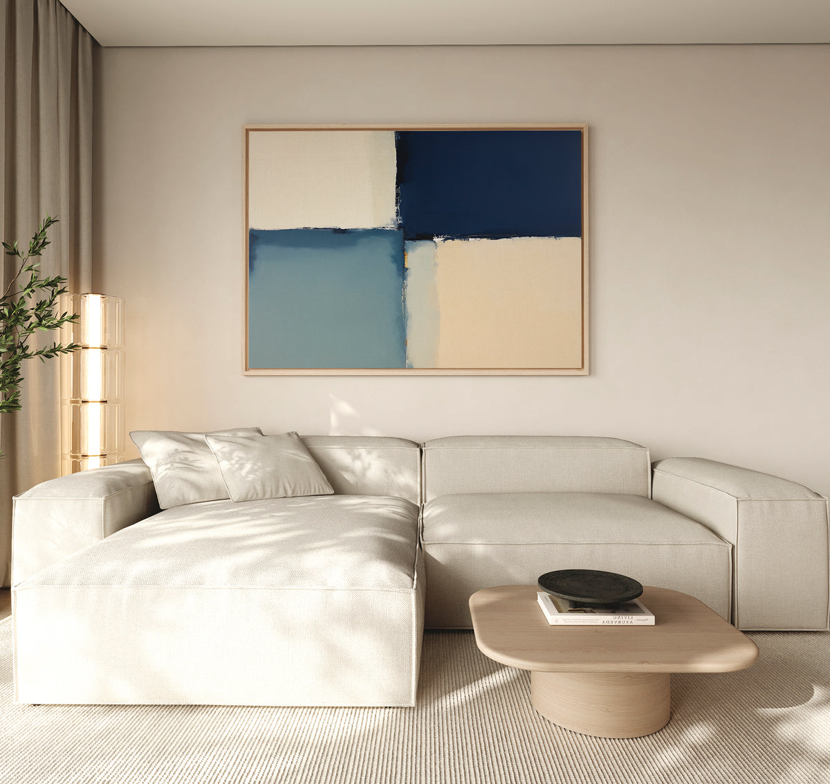 A modern living room features a light beige sectional, a round wood coffee table, and the Blue Quarters Canvas Art - Horizontal above. Sunlight fills the calm, minimalist space, making it perfect for contemporary living rooms.
