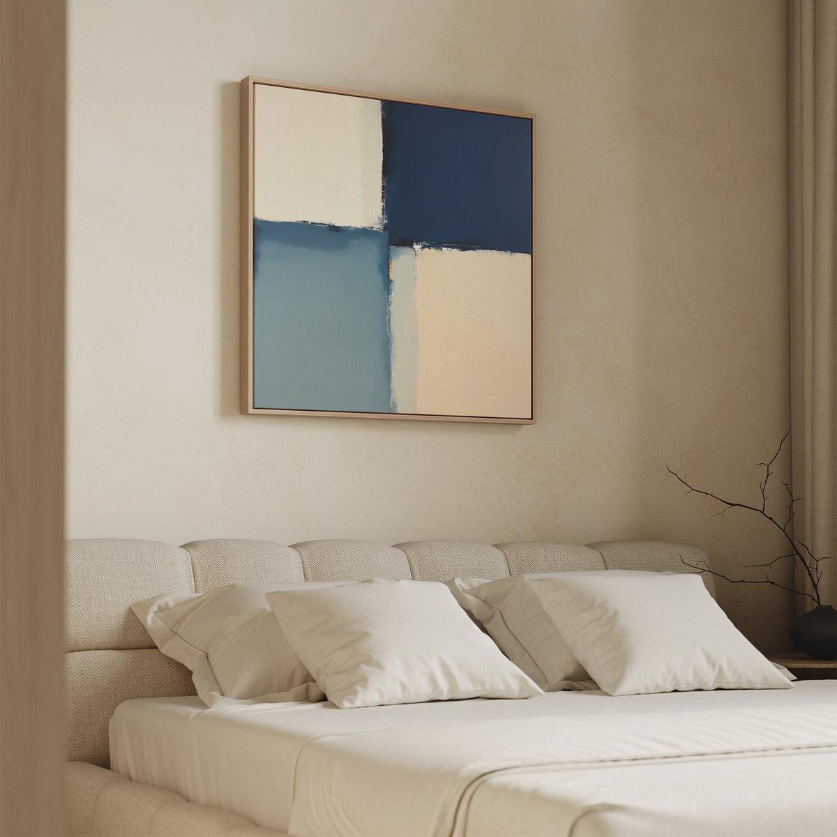 A minimalist bedroom with a beige upholstered bed, white bedding, and the Blue Quarters Canvas Art - Square featuring blue, cream, and beige blocks above the headboard. A bare branch in a vase accents the nightstand.