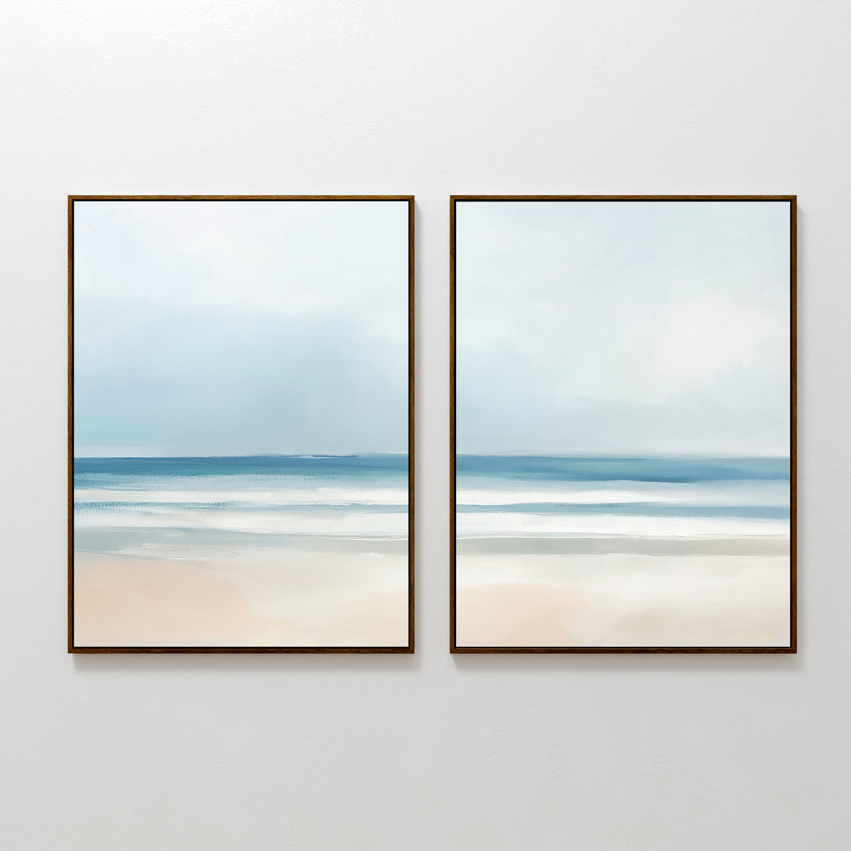 The Blurred Beach Scene - Set Of 2 features framed abstract prints in soft blue, white, and beige tones that depict calm ocean waves under a cloudy sky, perfect for bringing a serene touch to any space.