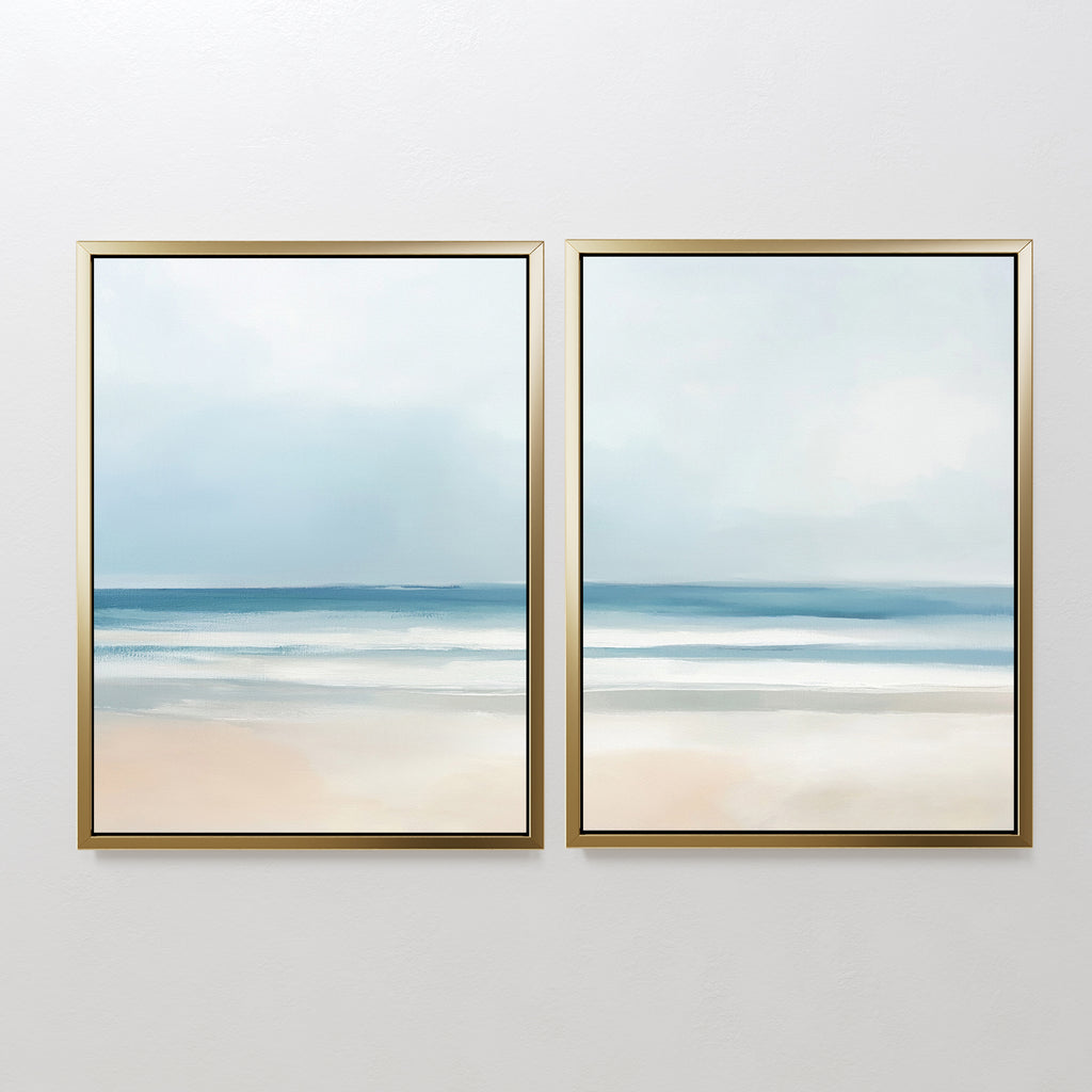 The Blurred Beach Scene - Set Of 2 features framed prints of a calm beach with soft blue, white, and beige tones—ideal coastal wall art for serene decor with gentle waves, sand, and an overcast sky.