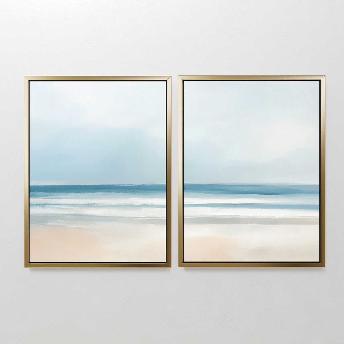 The Blurred Beach Scene - Set Of 2 features framed prints of a calm beach with soft blue, white, and beige tones—ideal coastal wall art for serene decor with gentle waves, sand, and an overcast sky.