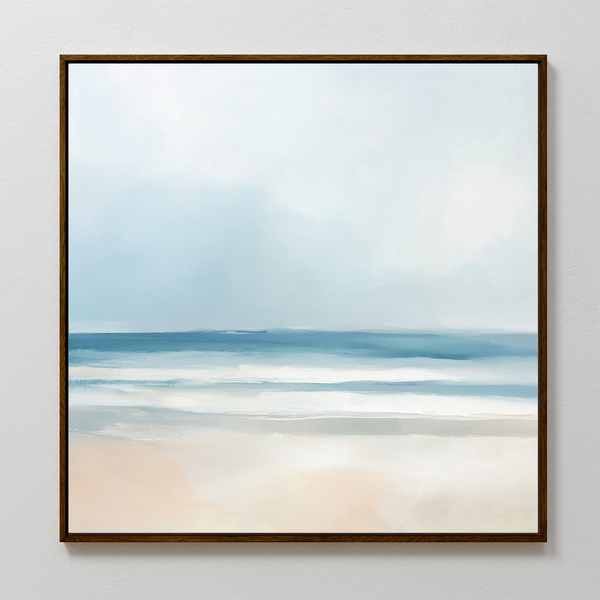 The Blurred Beach Scene Canvas Art - Square features a serene coastal print with soft blue waves, gentle white surf, and a pale sandy shore beneath a hazy sky. Its minimal colors and smooth brushstrokes create calming wall decor.