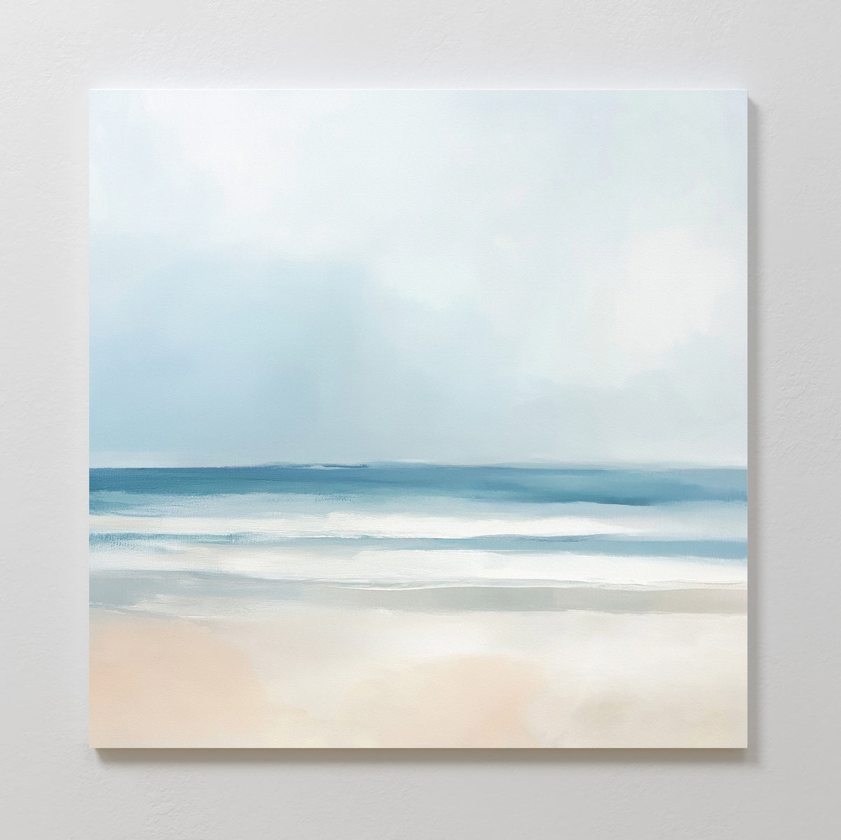 The Blurred Beach Scene Canvas Art - Square features a minimalist coastal design with soft blue, white, and beige tones depicting a tranquil beach—perfect as serene wall art.