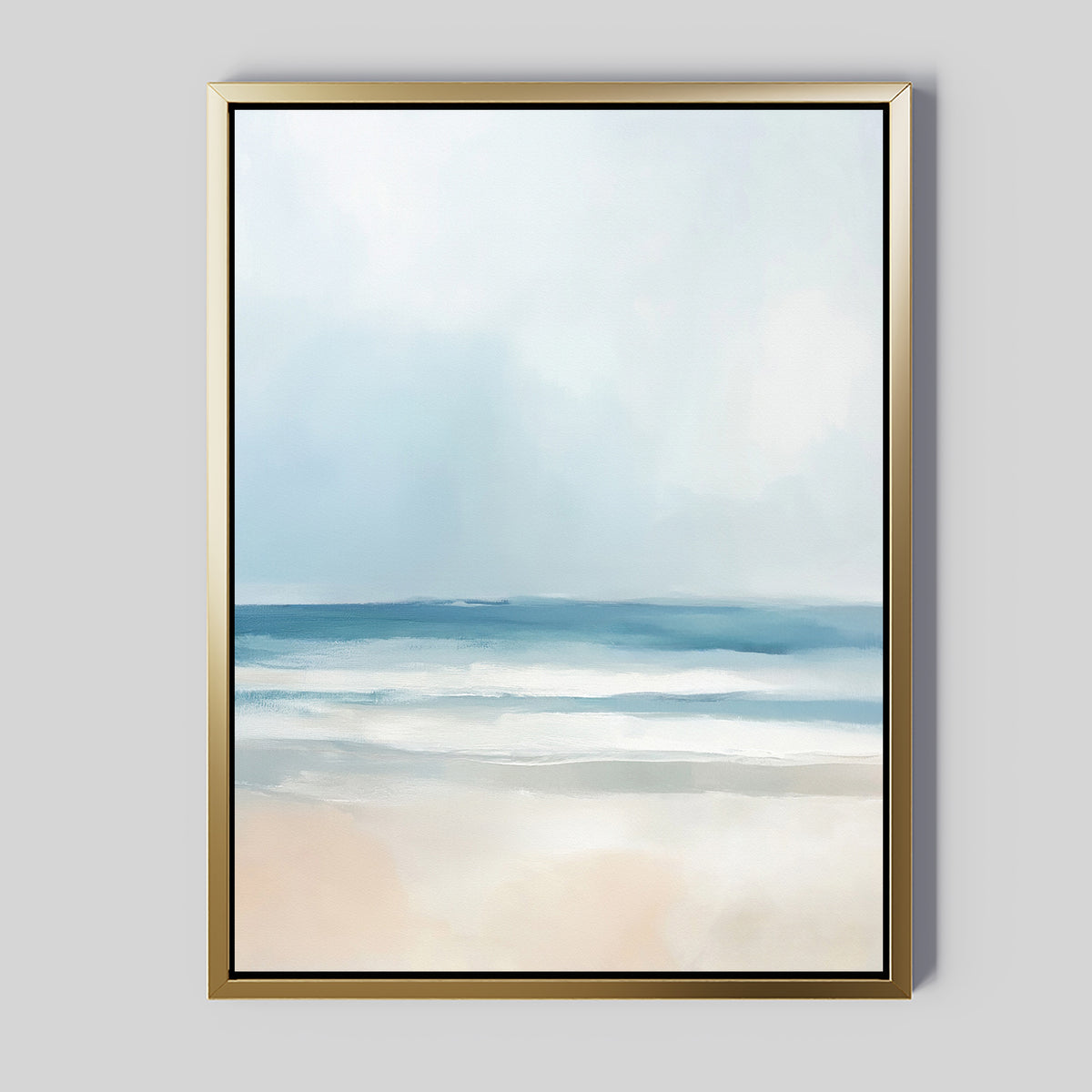 The Blurred Beach Scene Canvas Art - Vertical features a minimal, abstract coastal print of ocean, sky, and sand in soft blue and white tones. The gold frame with a thin black border adds elegance—ideal wall decor for serene beach-inspired spaces.